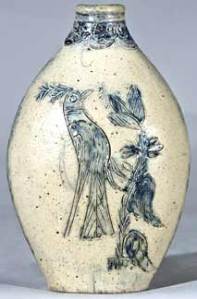 A rare 6½" high stoneware flask with flattened sides and incised bird and floral decoration sold for more than $40,000 at Crocker Farm Auction in July 2009