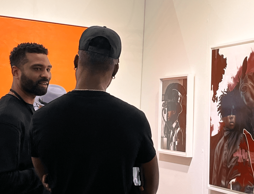 O’Neil Scott speaks with a patron at the LA Art Show
